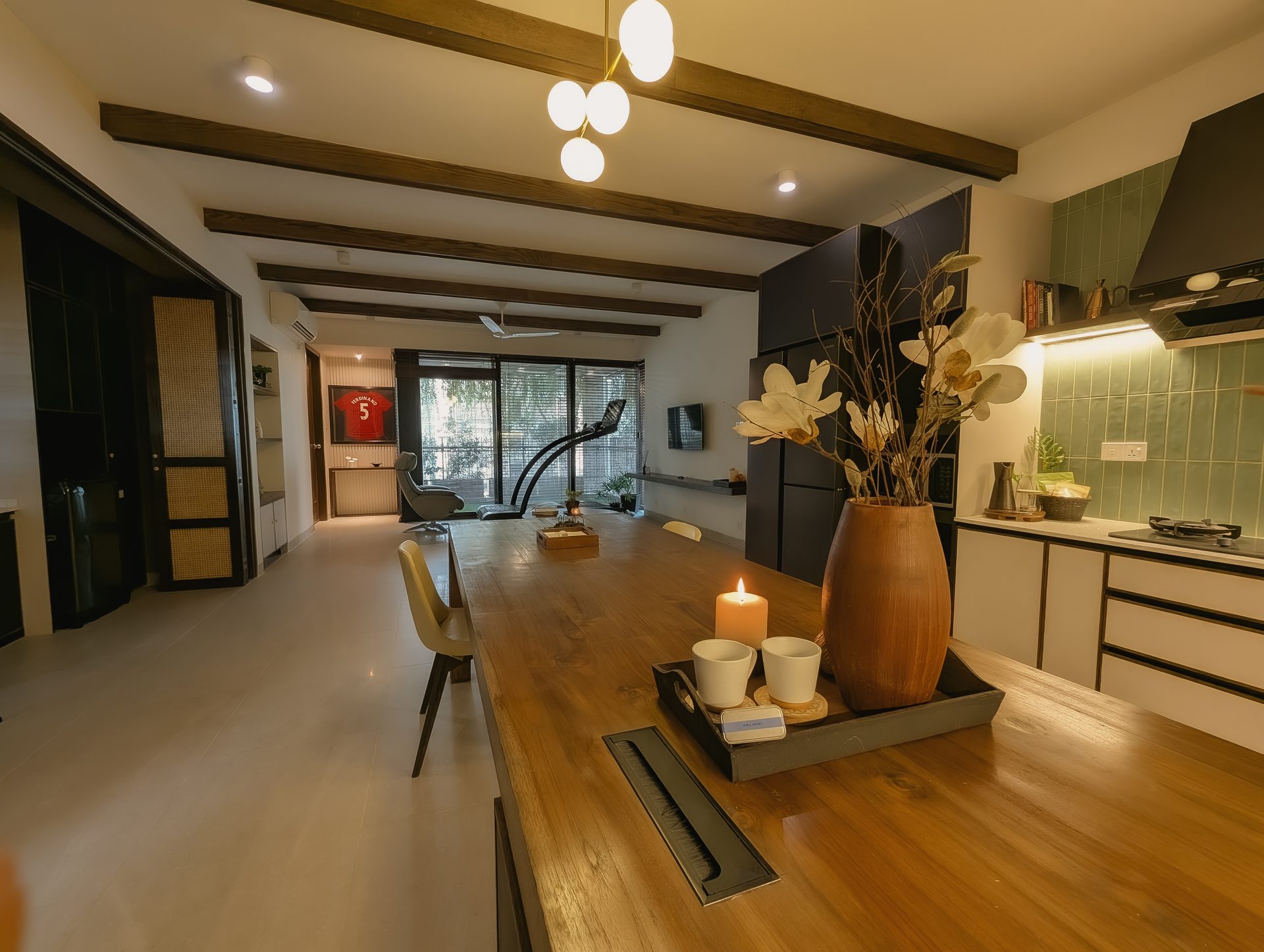 Long view across the Getaway Home kitchen and dining table toward the lounge and veranda