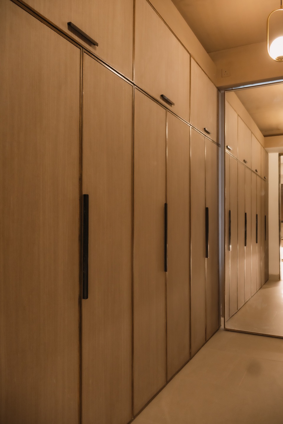 Walk-in closet cabinetry extending toward the bathroom