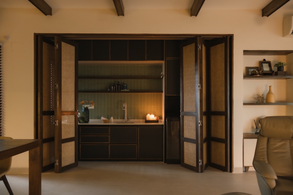 Open folding doors framing the green-tiled laundry