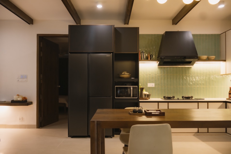 Kitchen cabinetry balancing charcoal and pale neutral finishes