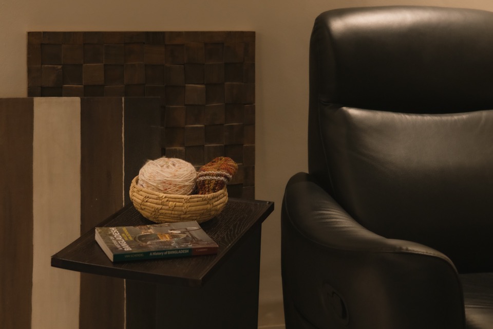 Leather reading chair beside a small timber side table