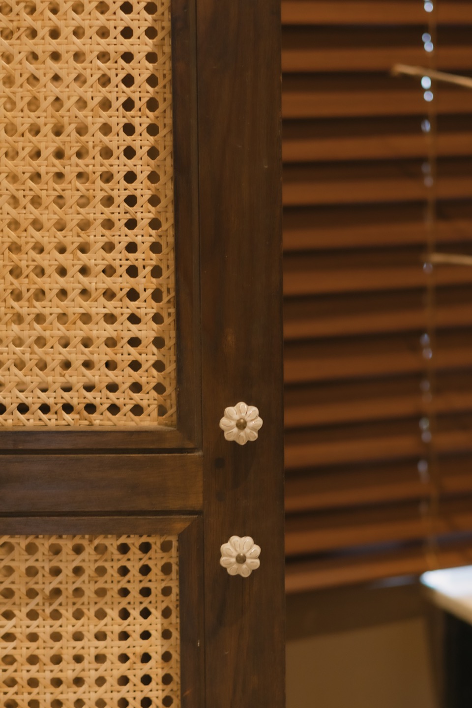 Floral ceramic knobs set into woven rattan panels