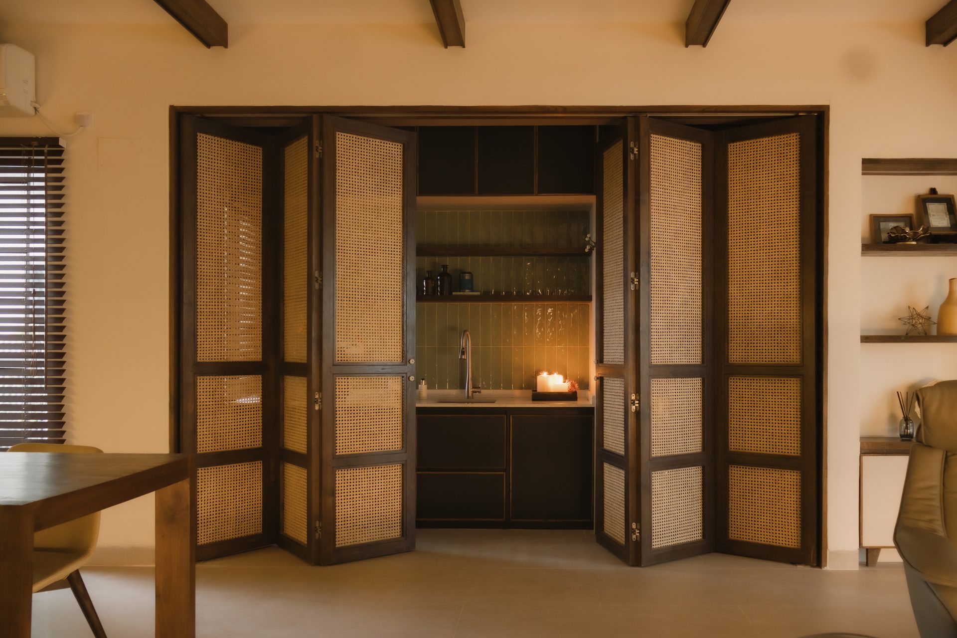 Woven rattan folding doors opened to reveal the green-tiled laundry