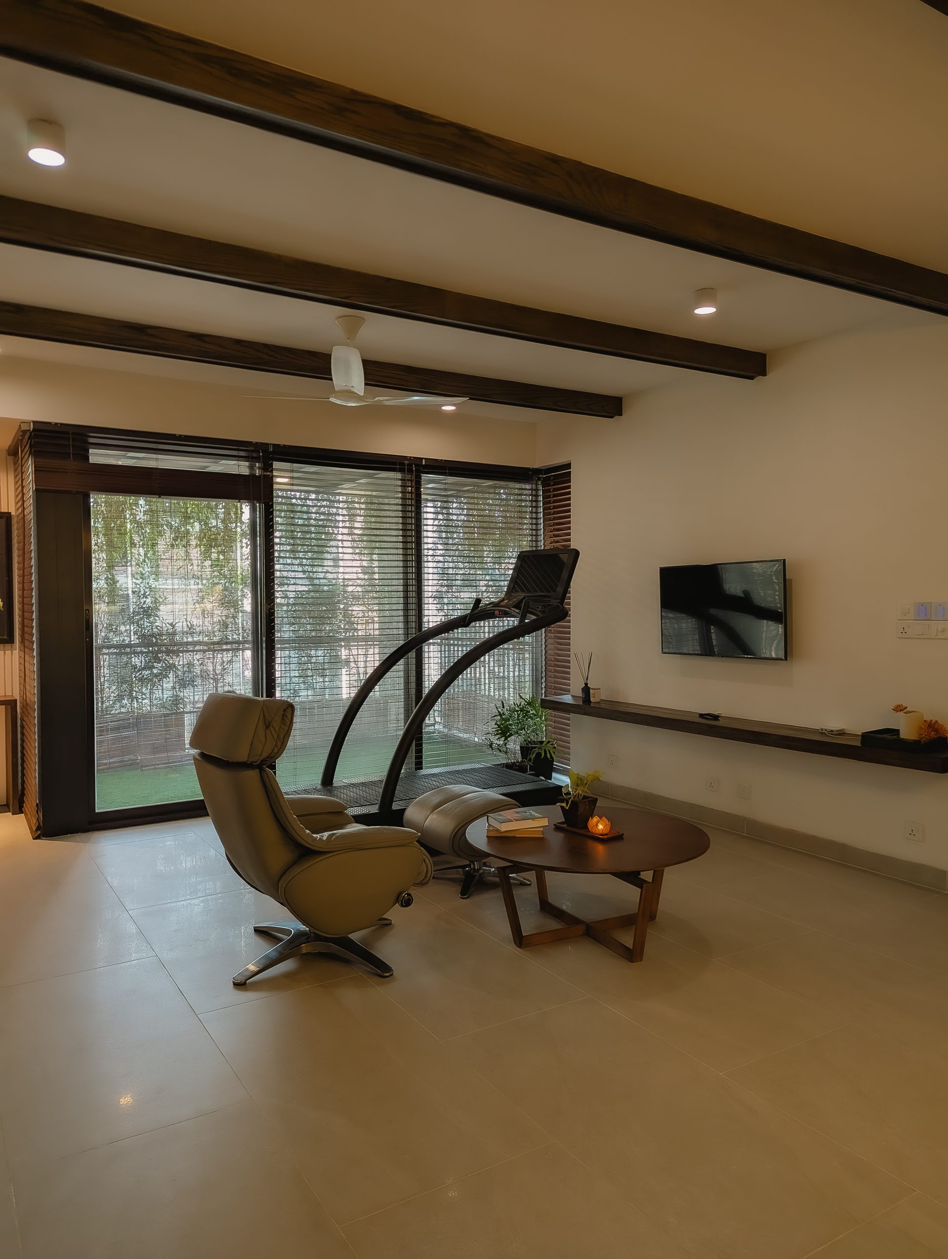 Getaway Home lounge facing broad windows and the planted veranda
