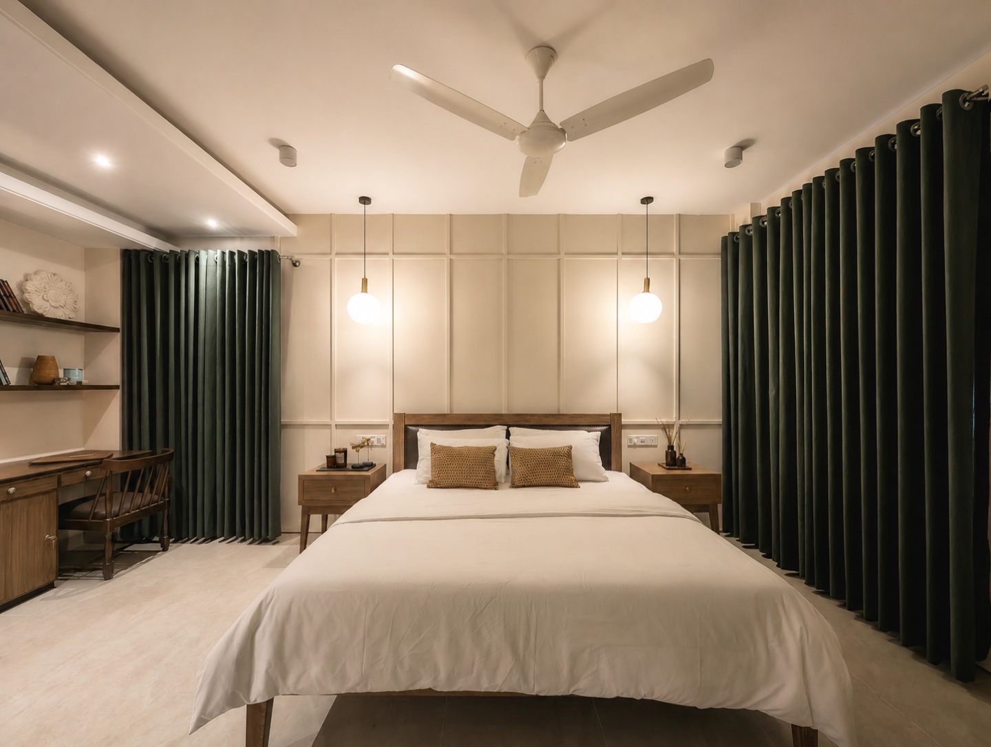 Front view of the primary bedroom with pale panelled walls and pendant lights