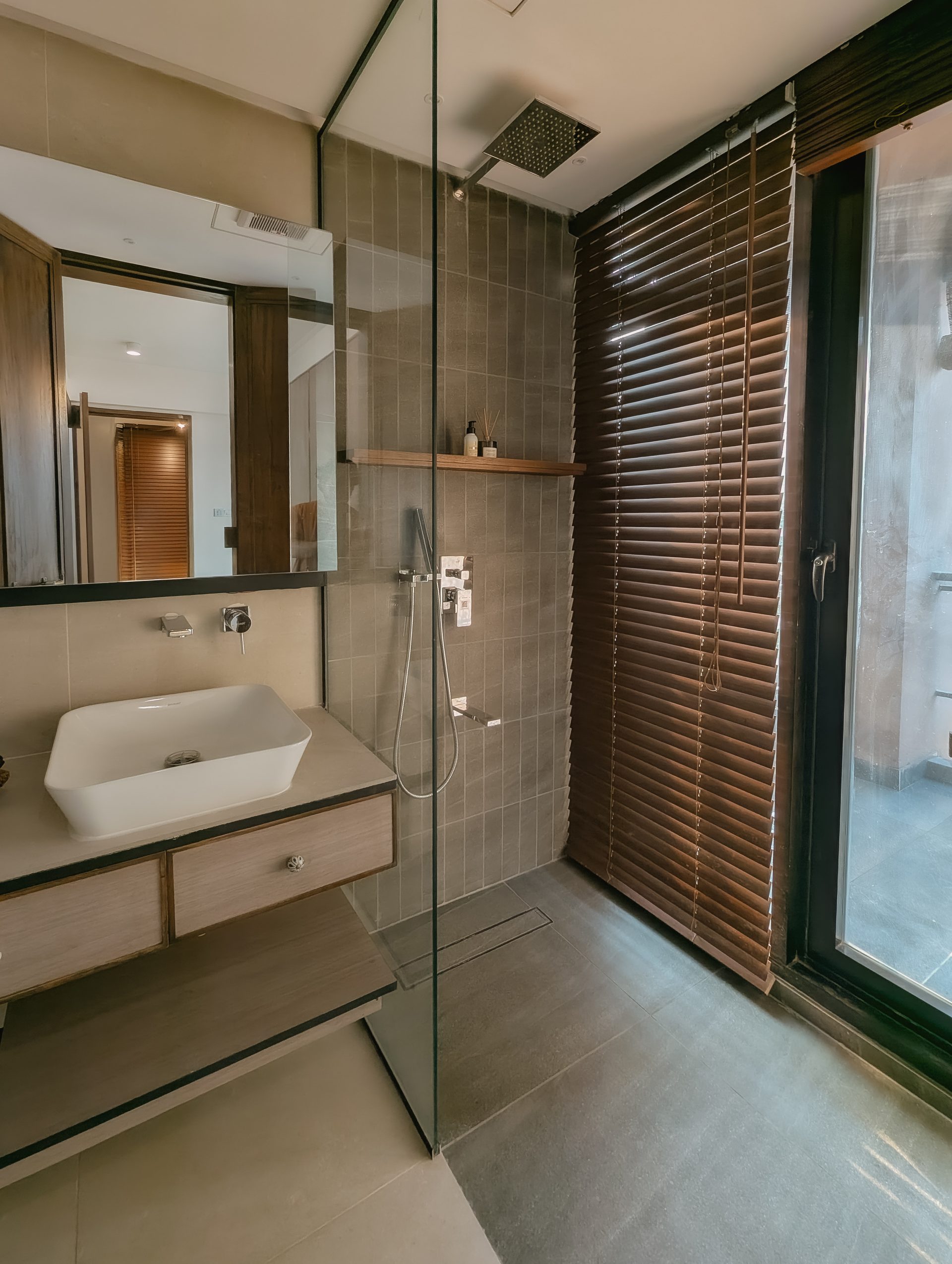 Floating timber vanity, mirror and glass shower in the second bathroom