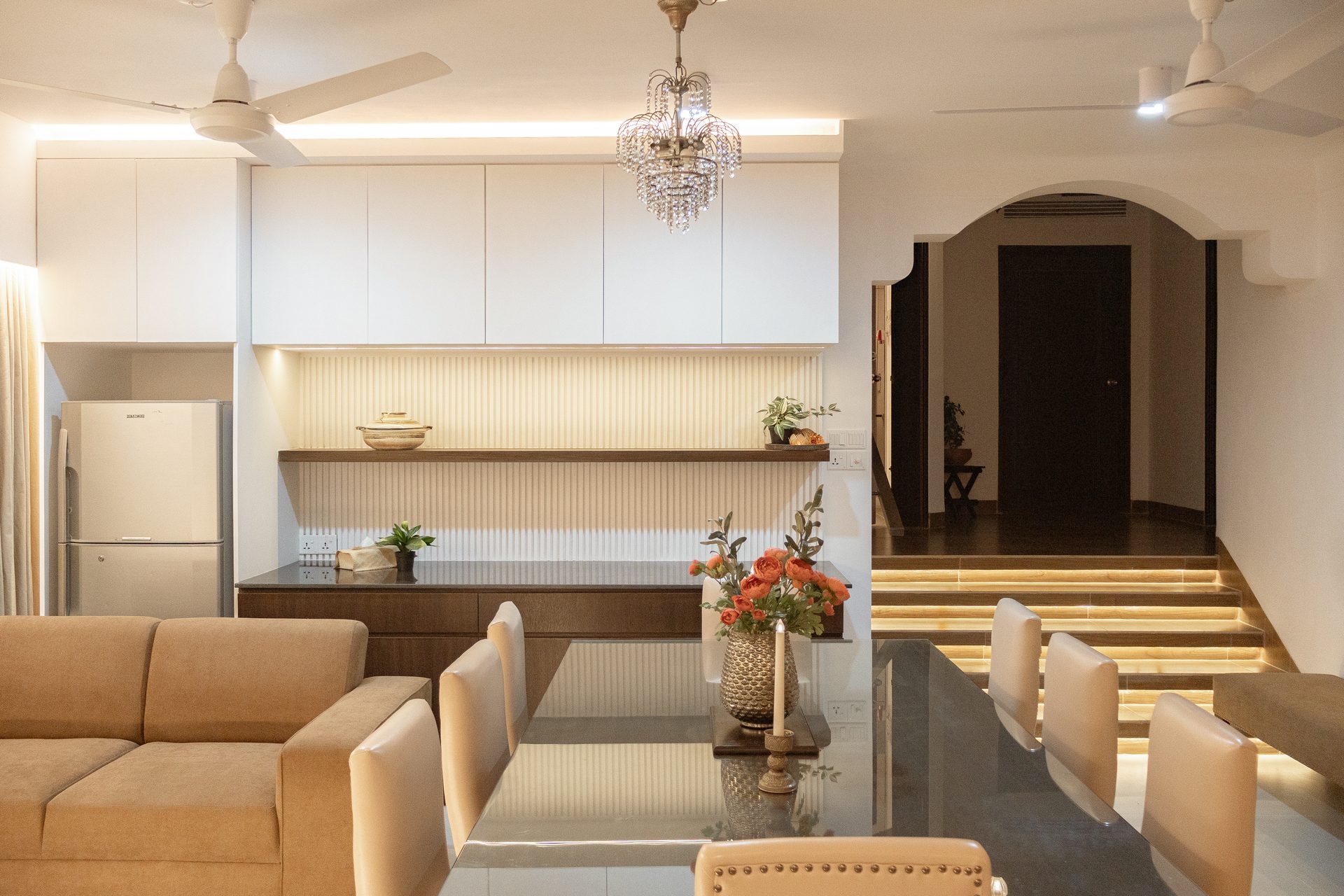 Dining room and illuminated steps leading to the private wing of A Multi-Generational Abode