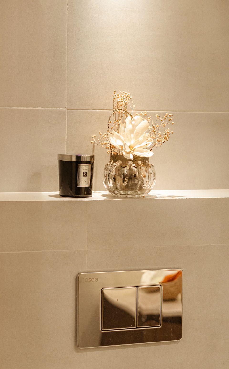 Decorative objects arranged along a bathroom ledge