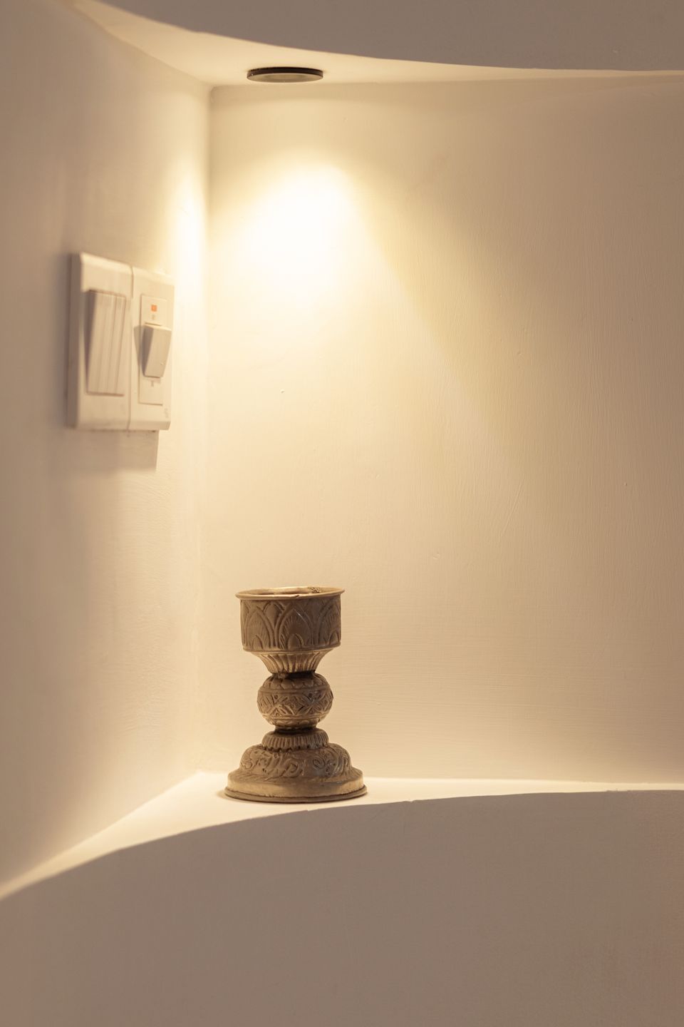 Small preserved vessel illuminated in a wall niche