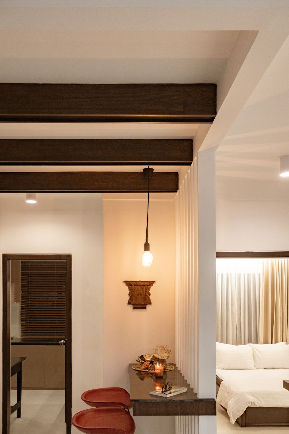 Preserved carved ornament aligned with a pendant and ceiling beam
