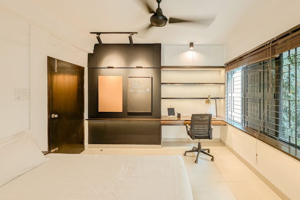 Shared bedroom study wall with integrated shelving