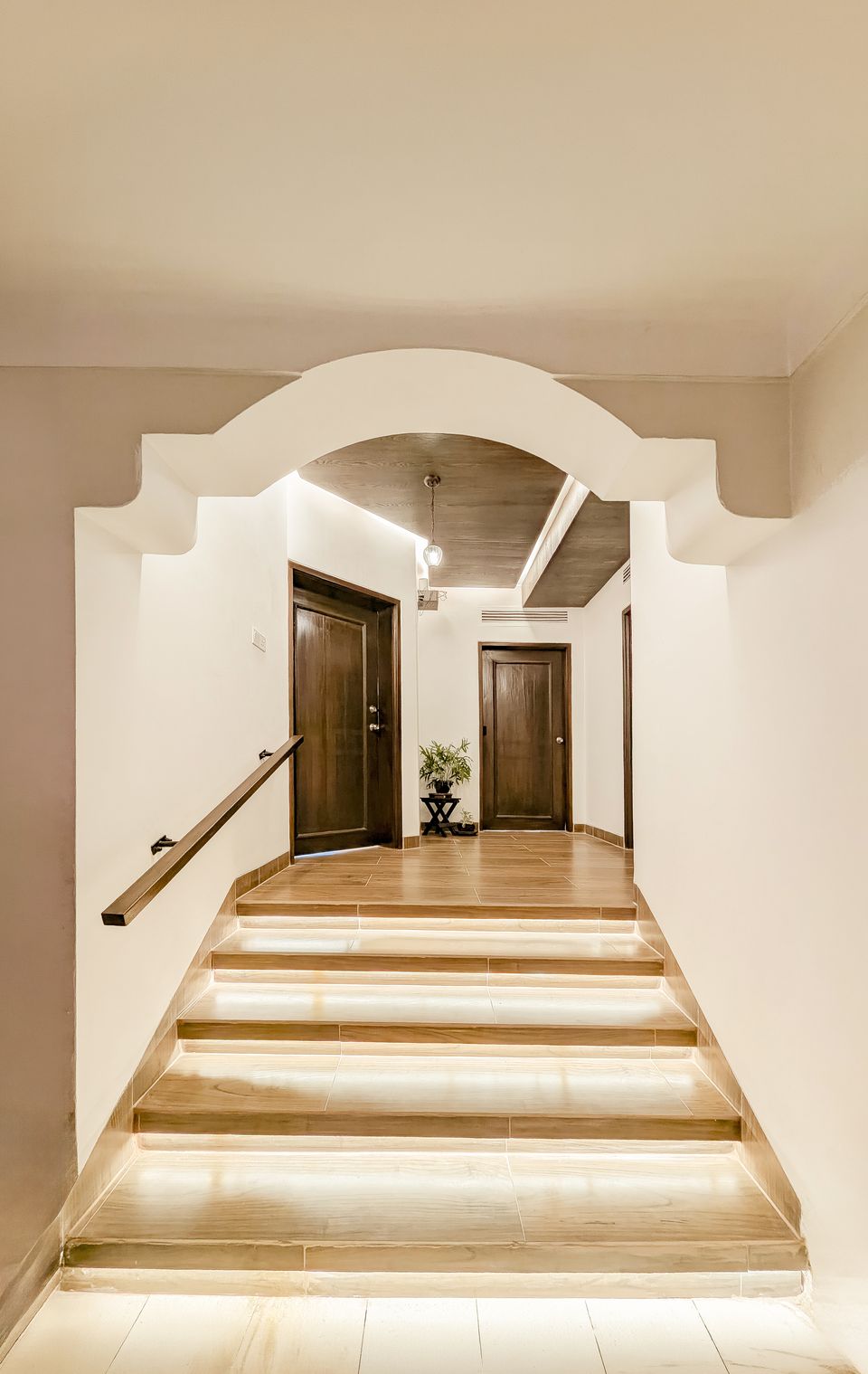Arched threshold and illuminated steps leading to the private wing