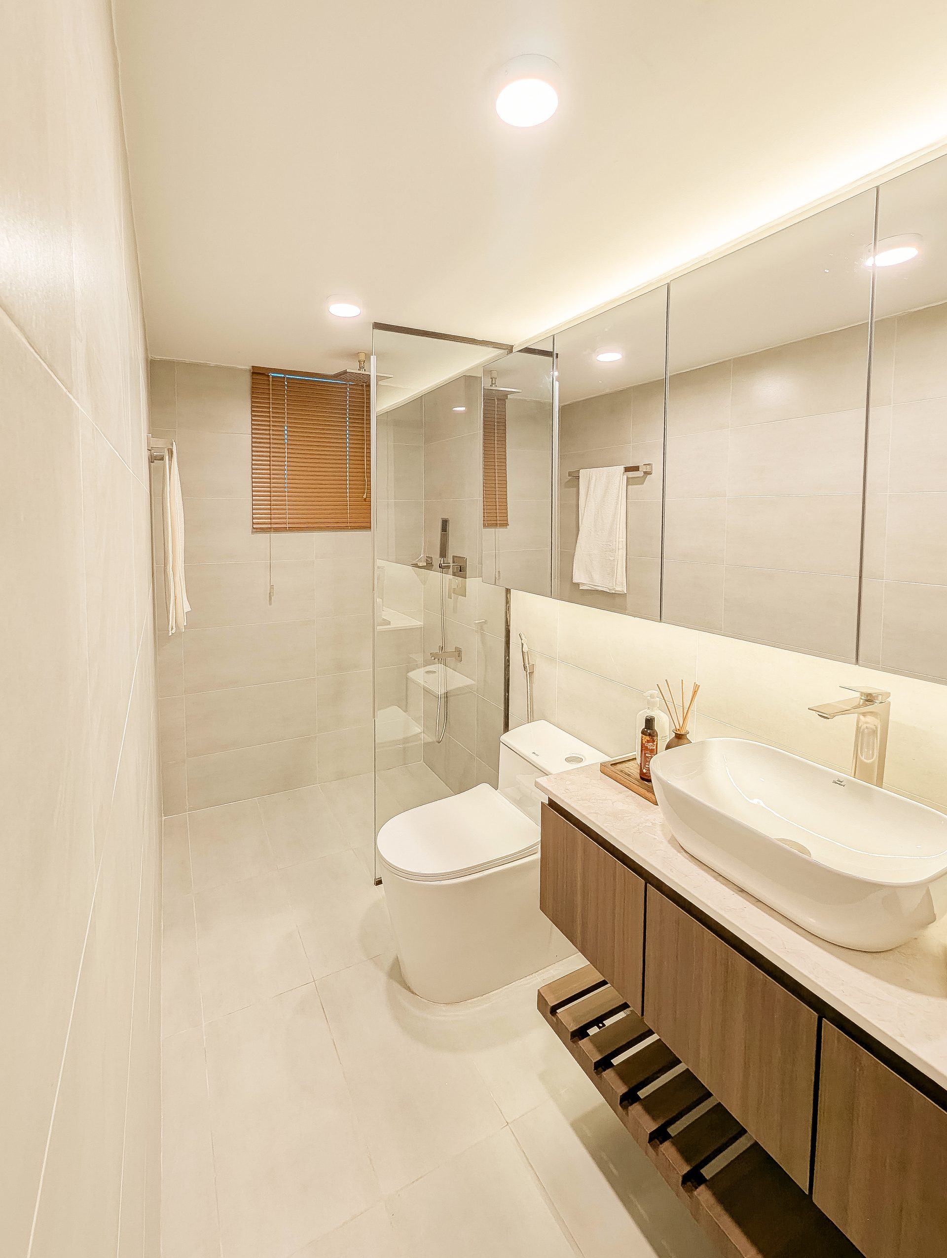 Second bathroom with a long mirrored cabinet and floating timber vanity