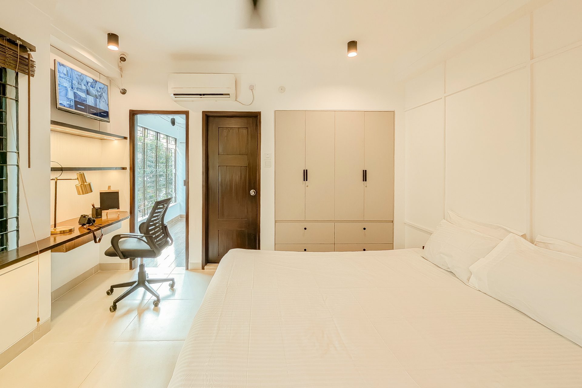 Second view of the shared bedroom study wall and open shelves