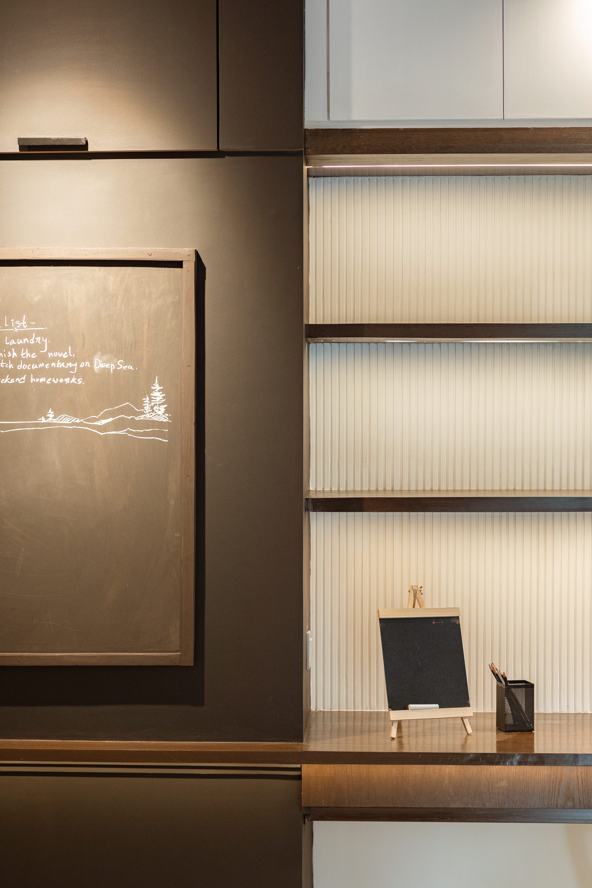 Integrated blackboard with handwritten notes beside bedroom shelving