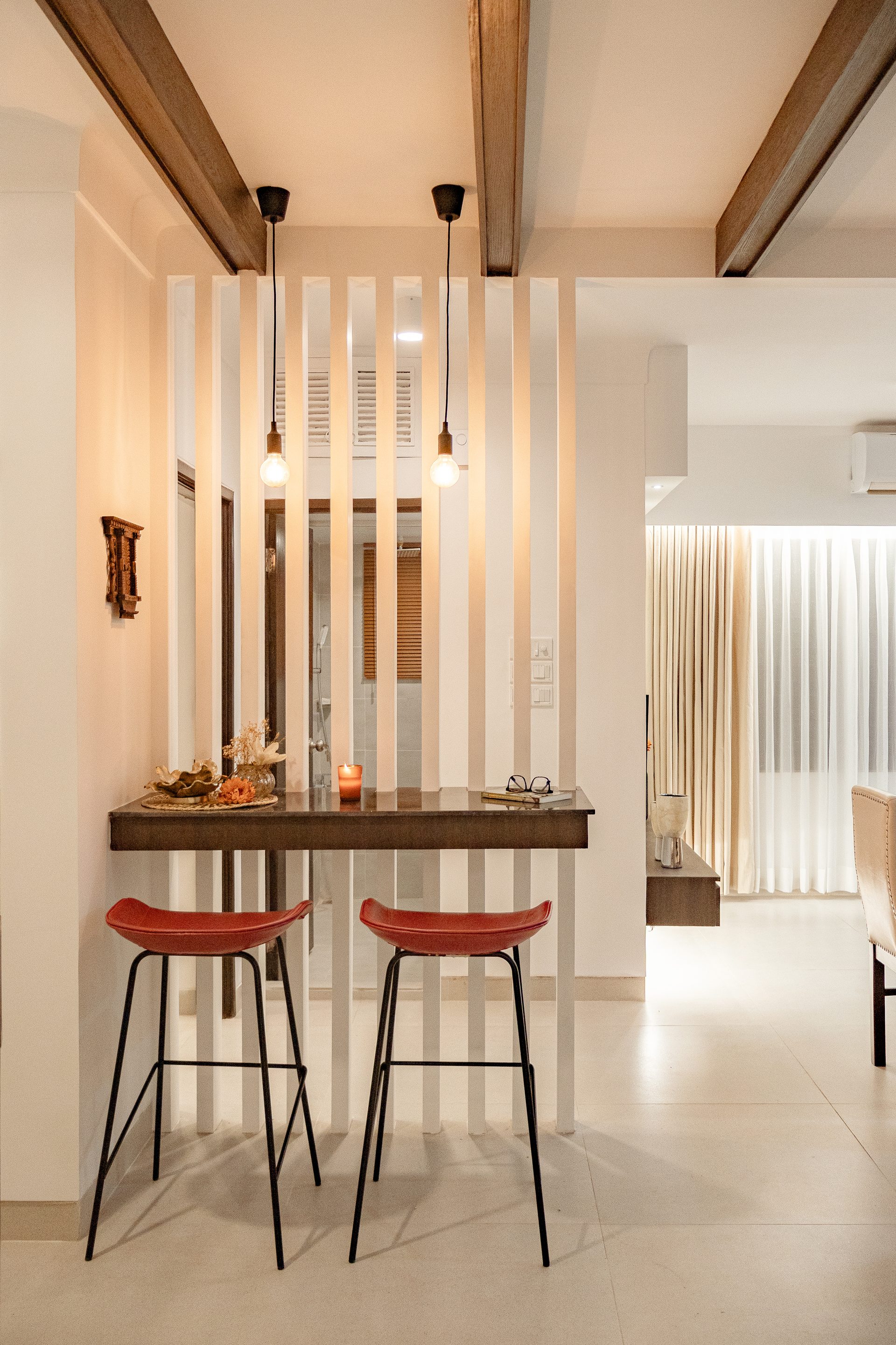 Close view of the breakfast counter, pendant lights and pale louvers