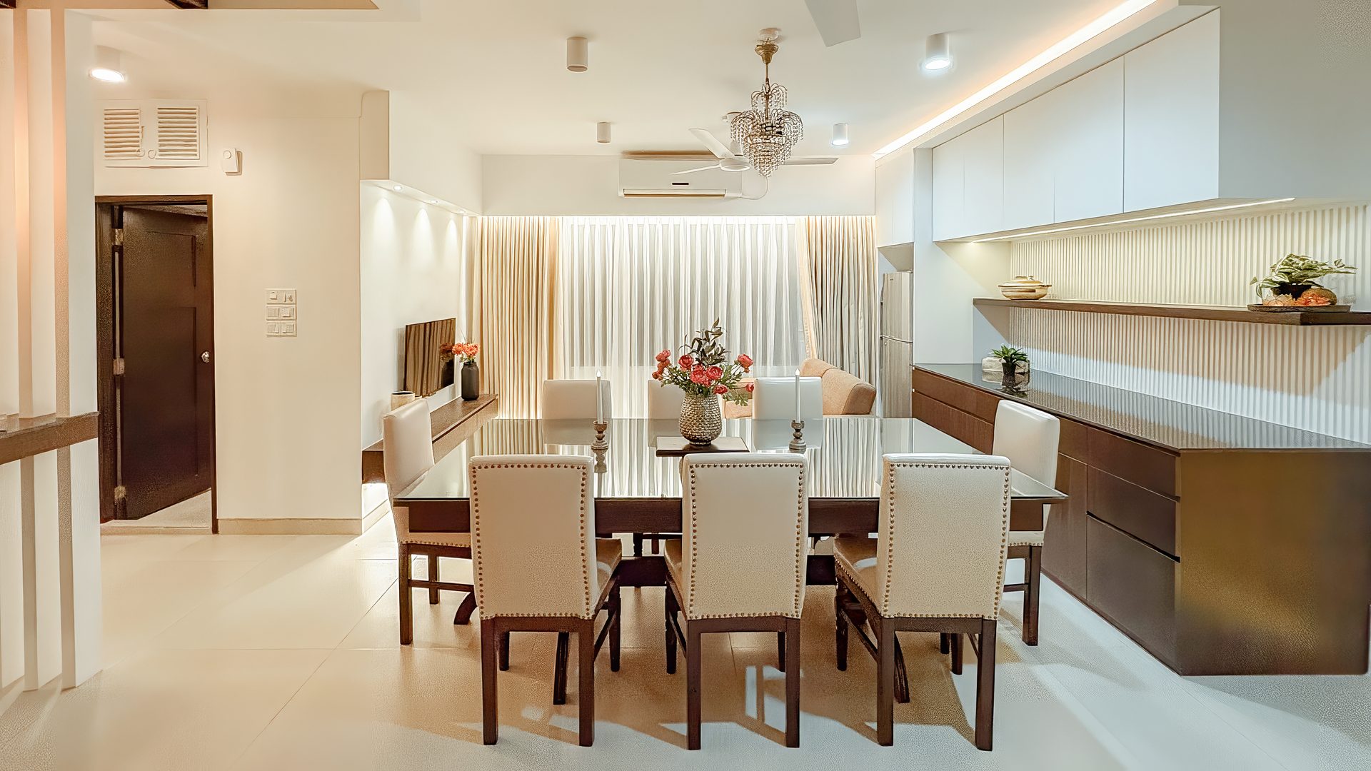 Eight-seat dining room with a restored dark timber table and pale chairs