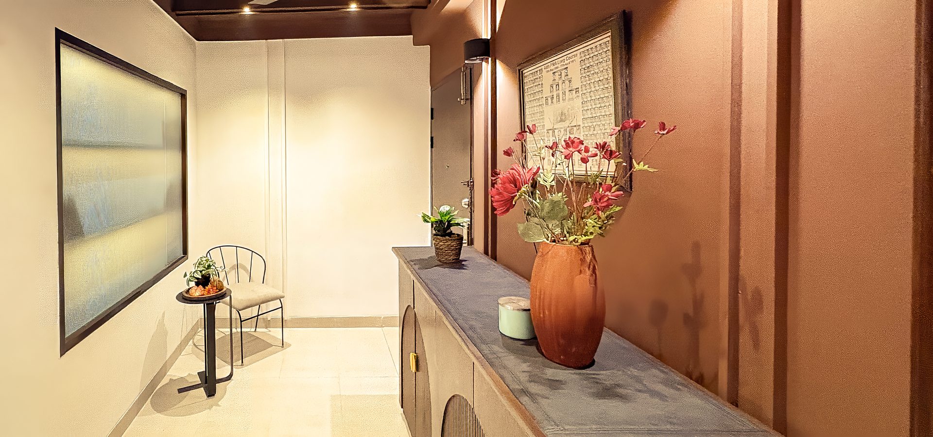 Dark brown foyer with a long console and flower arrangement