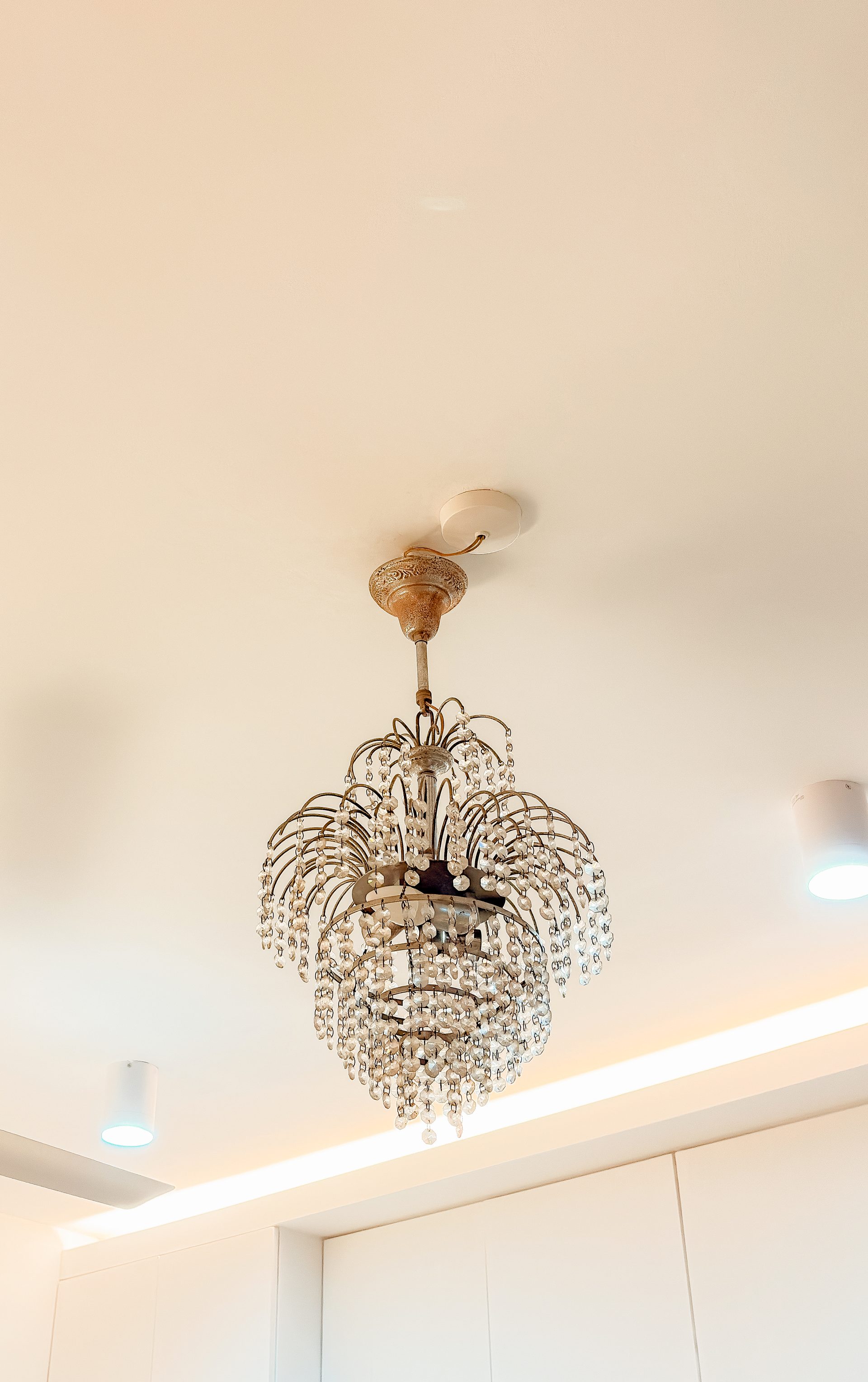 Ornate pendant light chosen to complement the home’s inherited details