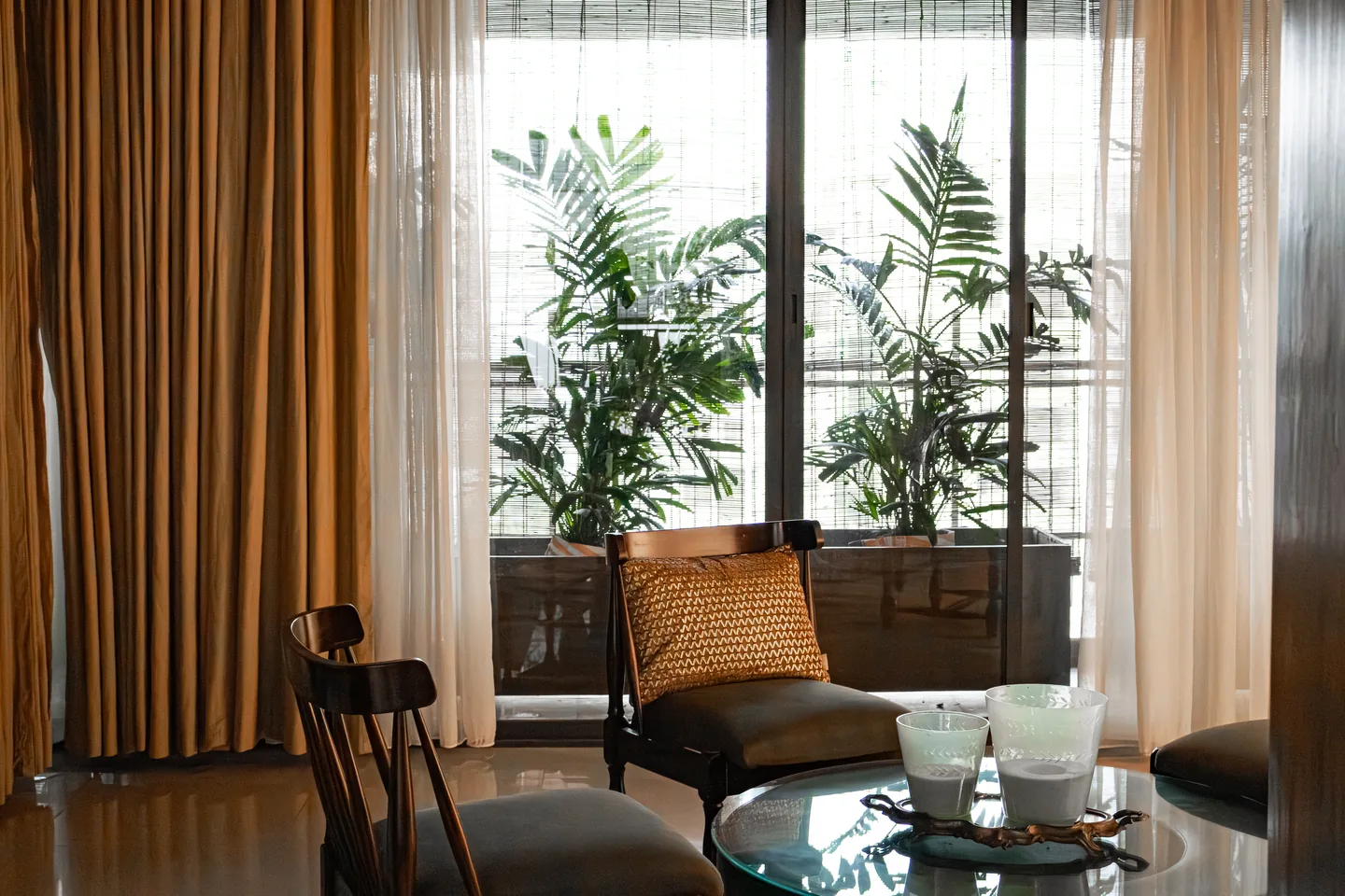 The Verdant Hideaway living room opening toward layered greenery